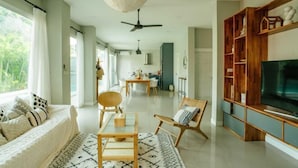 A spacious living area with a sofa, a coffee table, and a TV stand. - Private Pool Villa 6 Bedroom - Cloud Nine Villa (Chiang Mai)