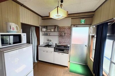 Kikai Island Rakuraku Stay “Room 201” – Retro island life in a tropical nostalgic apartment.