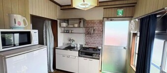 Kikai Island Rakuraku Stay “Room 201” – Retro island life in a tropical nostalgic apartment.