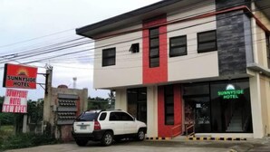 A two-story building with a sign for Sunnyside Hotel. - Sunnyside Hotel (Santo Tomas)