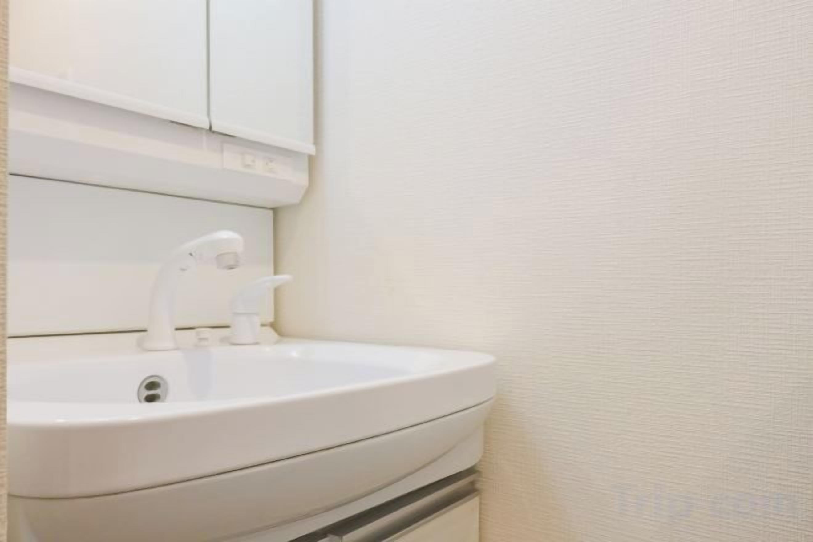 A white bathroom sink with a mirror above it.