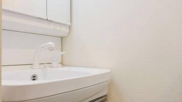 A white bathroom sink with a mirror above it.