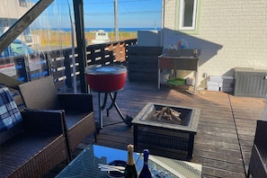 A deck with wicker furniture, a grill, and a fire pit. - KandoStay Kujyukuri SORA Terrace (Ichinomiya)