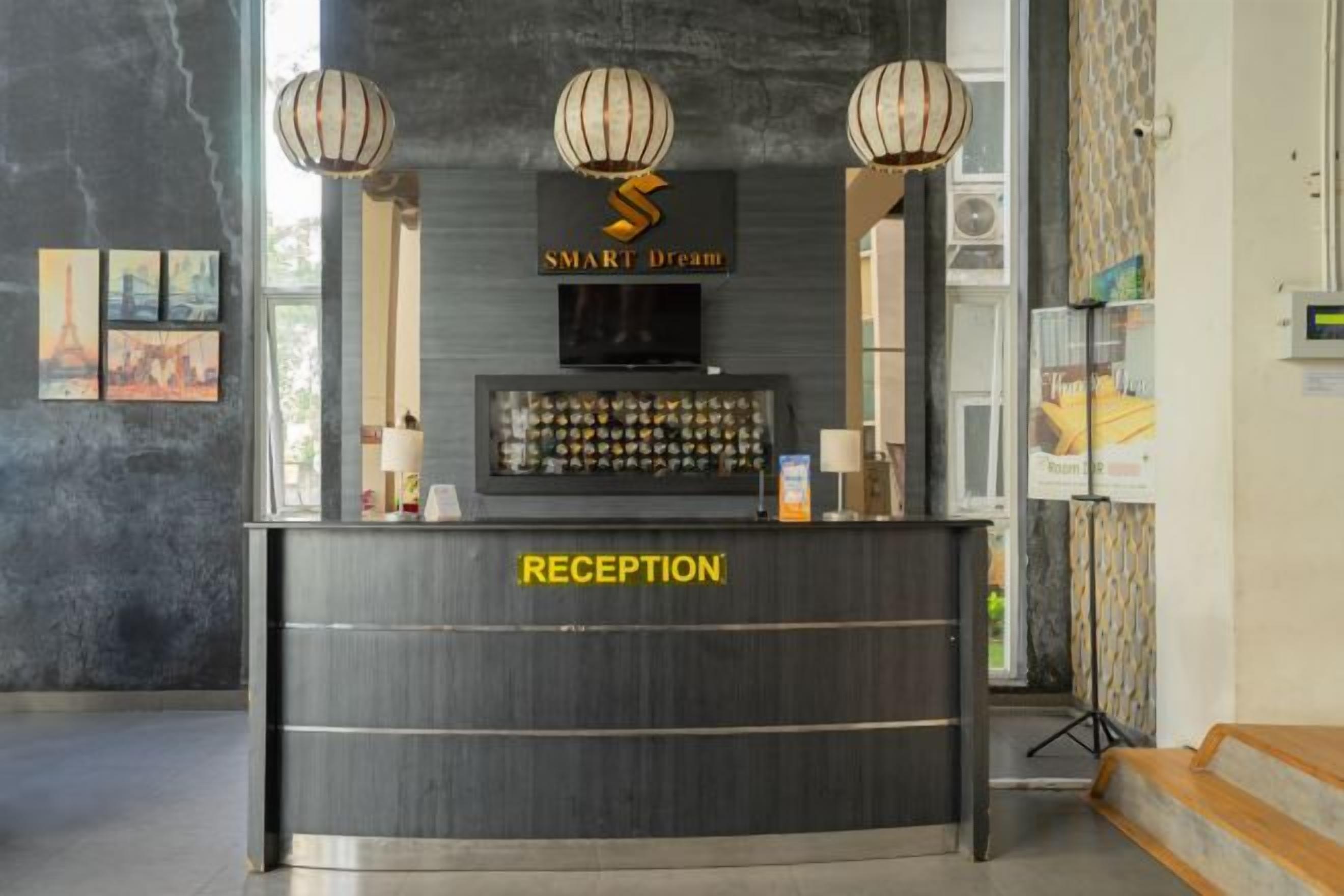 A reception desk with a 'SMART Dream' sign, a digital display, and a 'RECEPTION' label.