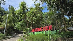 A sign for 'AMAZING TEN HOTEL & MOUNTAIN RESORT' surrounded by lush greenery. - Amazing View Mountain Resort Laguna (Mabitac)