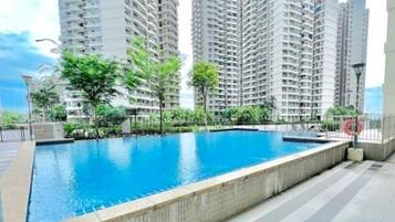 A swimming pool surrounded by high-rise residential buildings.
