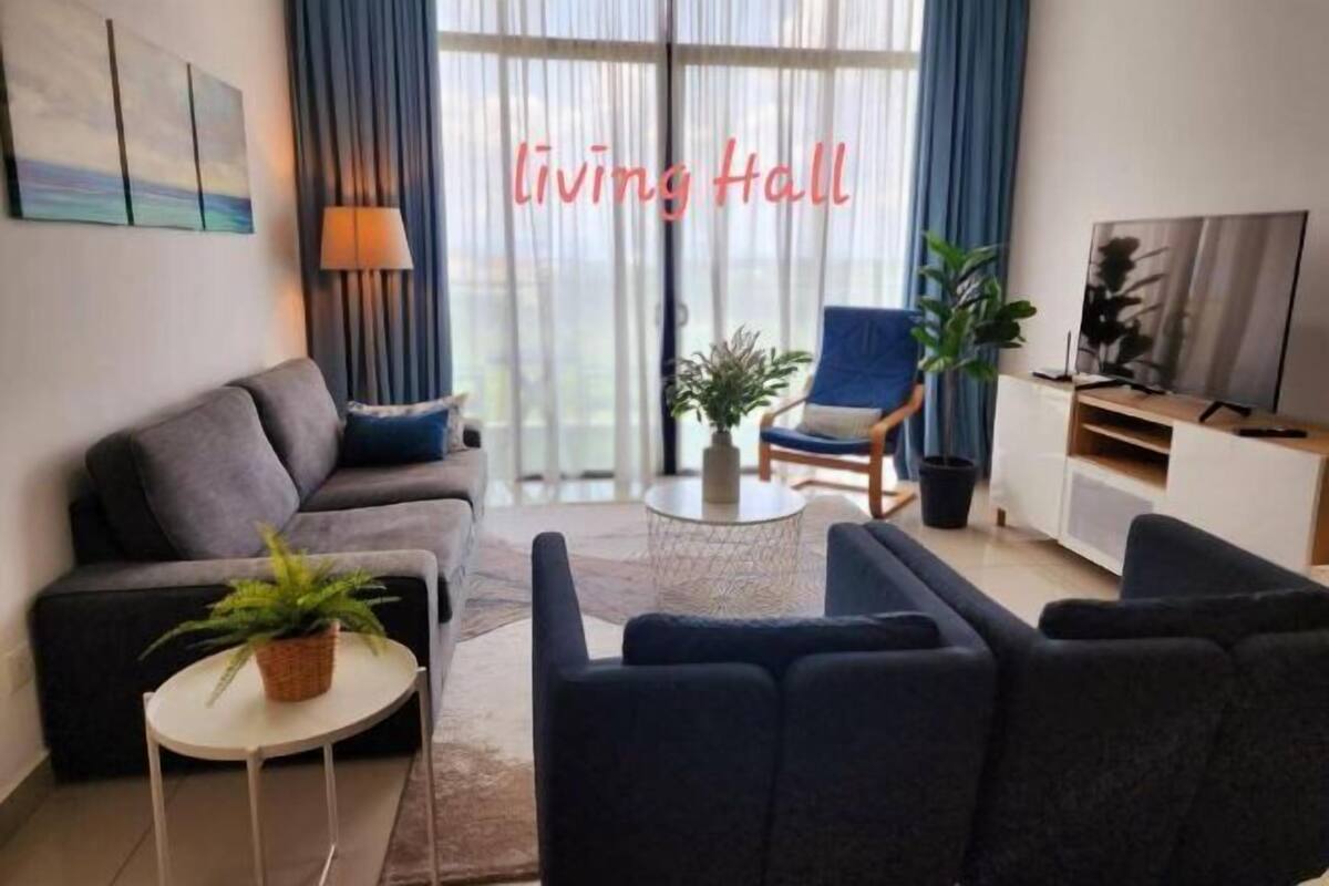A living room with a sofa, armchair, coffee table, and a TV stand.