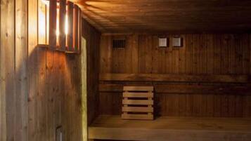 A wooden interior with a bench and a wall-mounted light fixture.