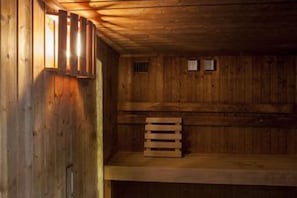 A wooden interior with a bench and a wall-mounted light fixture. - Holiday Inn NORWICH by IHG (Norwich)