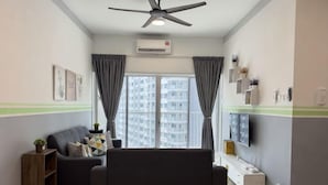 A living room with a sofa, a TV, a ceiling fan, and a window with curtains. - Razak City Residences A3 by Favspace (Kuala Lumpur)