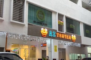 A restaurant named 'AZ TOMYAH' with a neon sign, located in a building with a large window and a visible phone number. - Razak City Residences A3 by Favspace (Kuala Lumpur)