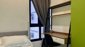 A bedroom with a bed, a desk, and a window with curtains. - Entire Unit & 2BR Near Legoland (Iskandar Puteri)