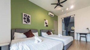 A hotel room with two beds, a desk, and a ceiling fan. - The Pano by Minsu (Kuala Lumpur)