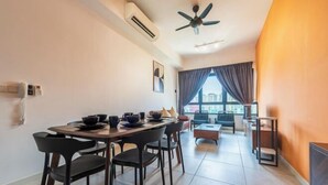 A modern dining area with a table set for four, a ceiling fan, and a view through a large window. - The Pano by Minsu (Kuala Lumpur)