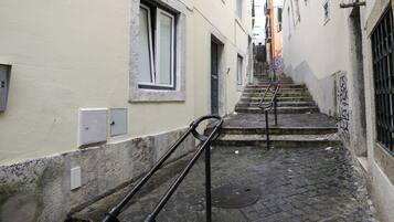 A narrow alleyway with a staircase leading to a higher level.