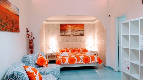 A bedroom with a bed, two bedside tables, a wall-mounted shelf, and a painting. - Entire Villa Grace Amalfi with Jacuzzi & stunning sea view – sleeps up to 14–20 (Amalfi)