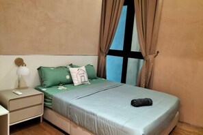 A bedroom with a bed, a nightstand, a lamp, and a window with curtains. - L23-ParadigmMall Residence Skudai JB 3R2B-10pax (Tebrau)