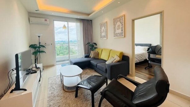 A modern living room with a sofa, a coffee table, a TV, and a ceiling fan.