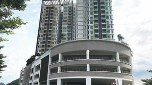 A multi-story building with a curved facade and balconies.