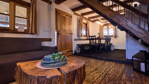 A rustic interior with a wooden staircase, a dining area, and a cozy seating area. - Holiday Home Gaborcina by Villas Guide (Popovaca)