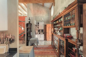 A kitchen with wooden cabinets, a dining table, and a kitchen island.