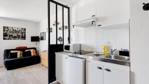 A compact kitchen with a microwave, sink, and refrigerator. - Apartment 'L'aventurier' – Steps from Futuroscope, Sleeps 4 (chasseneuil du Poitou)