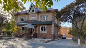A two-story building with a sign 'N&S' on the front, a covered entrance, and a car parked in front. - N&J Hotel-Process equipment only (Jizzakh District)