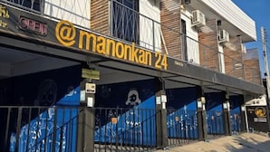 A building with a sign reading "Manonkan 24" and a "Check In" sign. - Manonkan Kranuan (Kranuan)