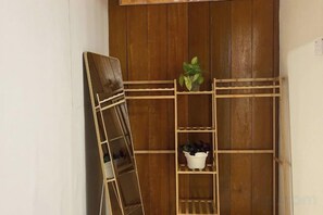 A wooden shelving unit with plants and a mirror. - Manson Goat Cottage (A) - Nature escape hideaway (Ulu Telom)