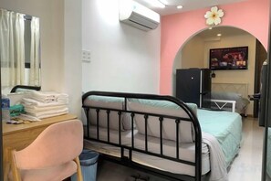 A bedroom with a bed, a desk with a chair, a TV, and a window with curtains. - Lunaria Maison - Local Side (Ho Chi Minh City)