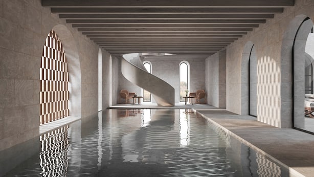 A modern interior with a central water feature, arched windows, and minimalist furniture. - Zannier Île de Bendor (Bandol)