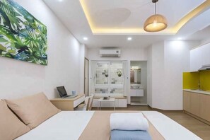Ein modernes Schlafzimmer mit einem Bett, einem Nachttisch und einem Laptop.