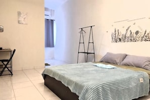 A bedroom with a bed, a desk, a chair, and a wardrobe. - Forget-Me-Not Pangkor Homestay 70 (Pangkor)