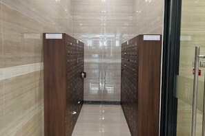 A corridor with a mirrored wall and a door at the end. - Vinhomes Skylake My dinh Hanoi-Nanahousing (Hanoi)