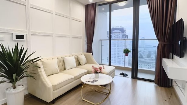 A modern living room with a sofa, coffee table, and a television.