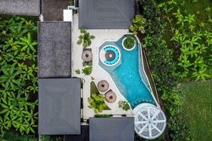 An aerial view of a resort with a swimming pool, umbrellas, and a gazebo. - Villa Pool Bar by BaliSuperHost (Bali)