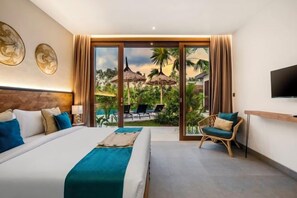 A hotel room with a large bed, a TV, and a view of a pool and palm trees. - Villa Pool Bar by BaliSuperHost (Bali)
