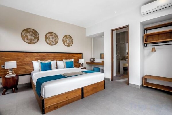 A modern hotel room with a large bed, bedside tables, and a wardrobe. - Villa Pool Bar by BaliSuperHost (Bali)