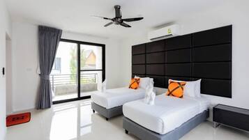 A modern hotel room with two beds, a ceiling fan, and a large window with a view.