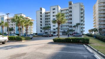 A multi-story parking lot with several cars and a white truck.