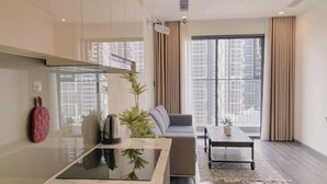 A modern apartment with a kitchen, living area, and large windows. - Sunshine Apartment - Vinhomes Ocean Park Ha Noi (Hanoi)