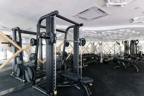 A gym with weightlifting equipment, benches, and mirrors. - ARTE MONT KIARA BY FEEL HOME (Kuala Lumpur)