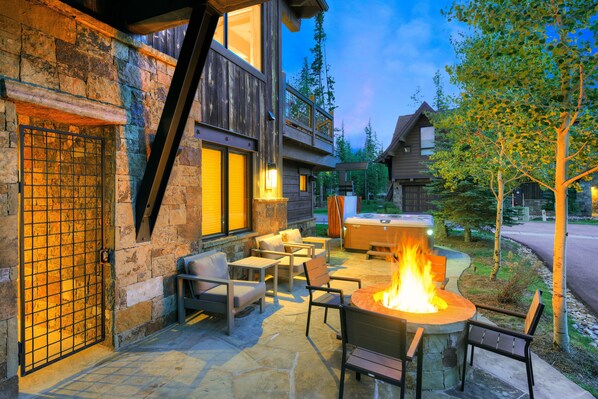 A stone building with a fire pit and outdoor seating.