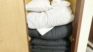 A storage area with neatly stacked pillows and folded blankets. - Nakano5chome-102 (Tokyo)