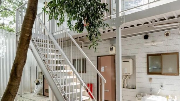 A multi-level indoor space with a staircase, a door, and a white utility box. - Nakano5chome-102 (Tokyo)