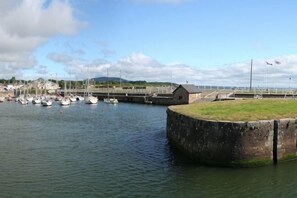 A harbor with boats, a lock, and a grassy area. - Tara Hill Estate (Wexford)