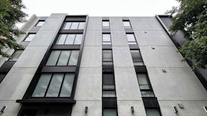 A modern building with a symmetrical facade, multiple windows, and a central entrance. - Cantabile Meidaimae (Tokyo)