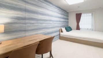 A modern bedroom with a bed, a desk, and a chair.