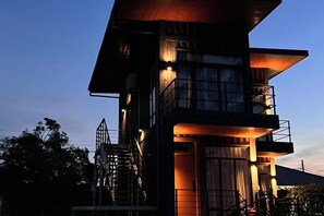 A multi-story building with a staircase, balconies, and large windows. - The Buwan Dive Resort (Semporna)