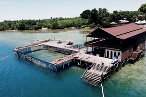 A floating structure with a dock, a covered area, and a staircase leading to the upper level. - The Buwan Dive Resort (Semporna)